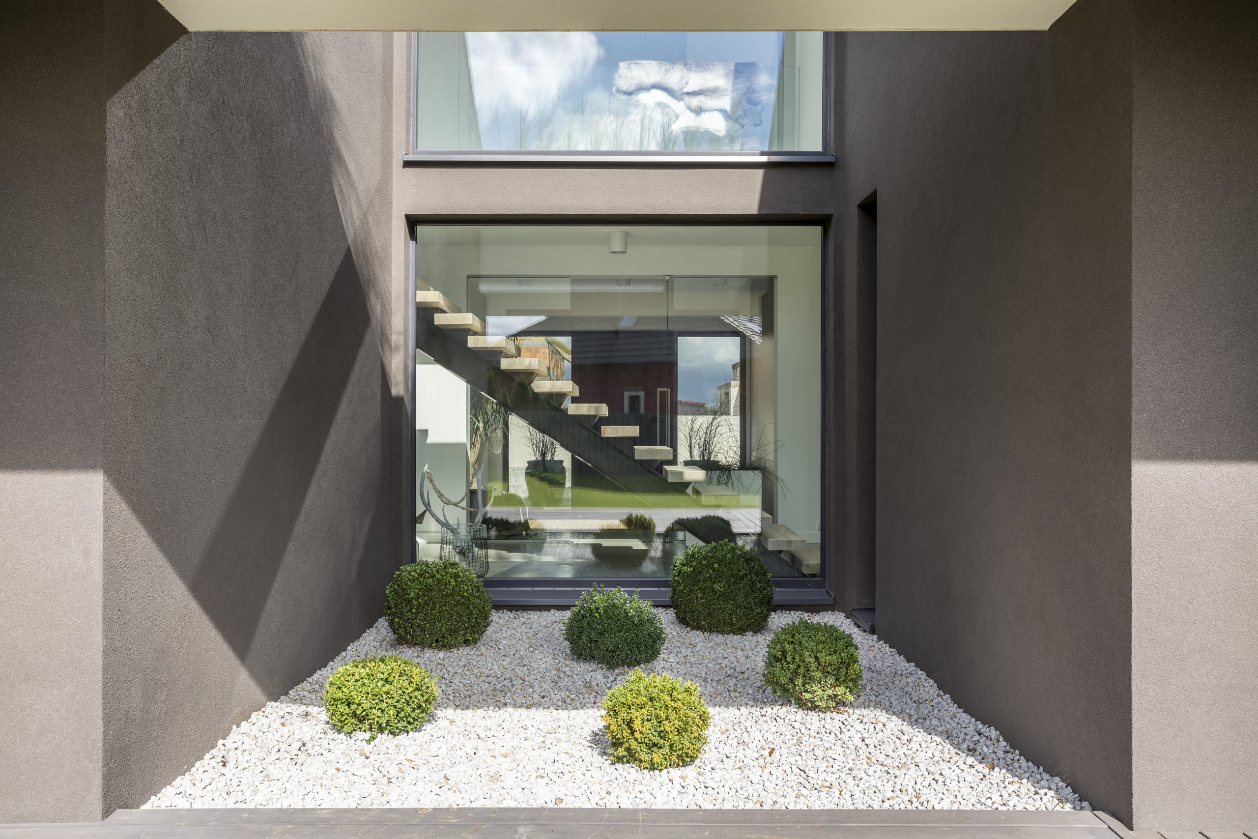 Big window in cubic niche of modern house