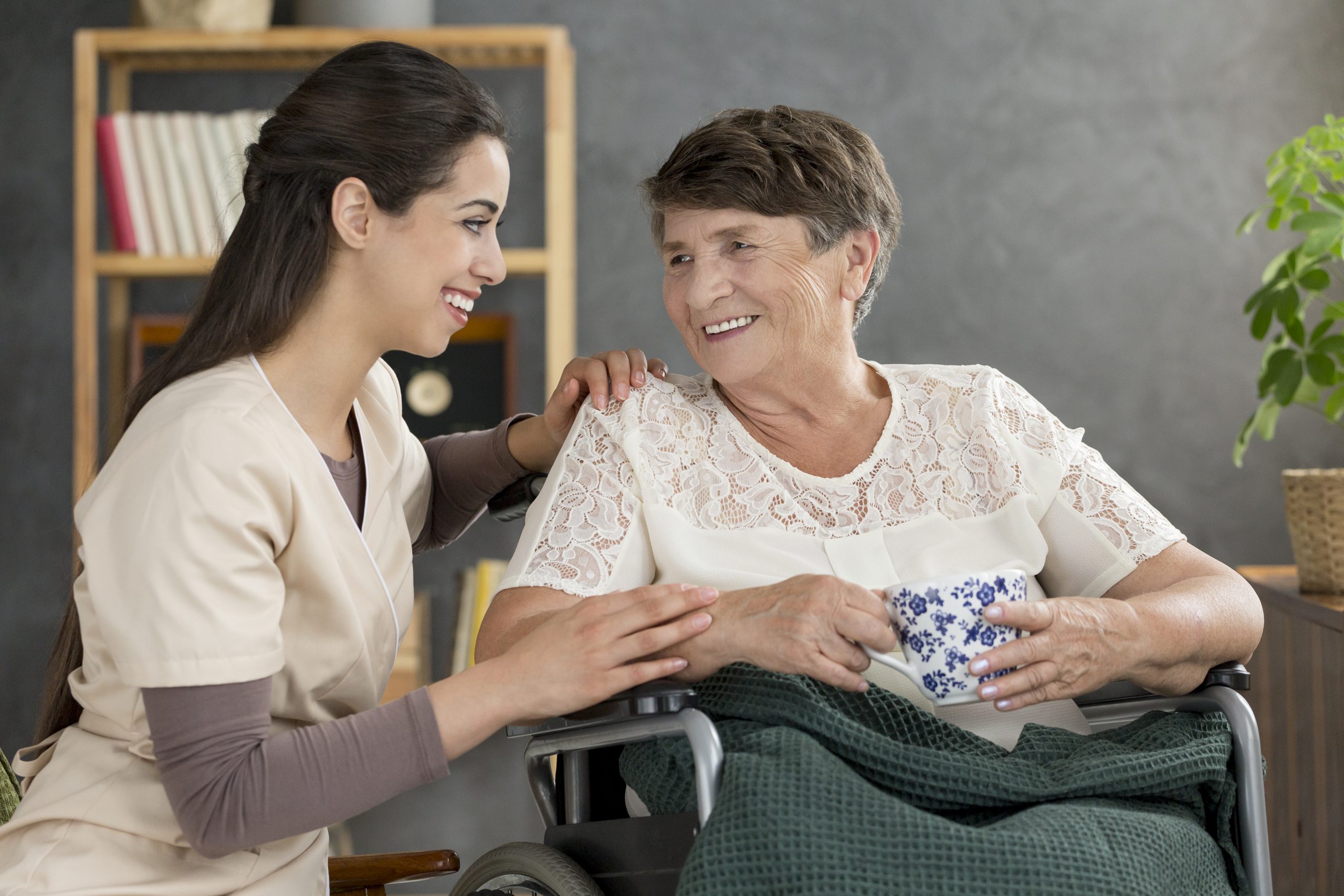 Friendly support worker assisting an NDIS participant with daily living tasks in Perth
