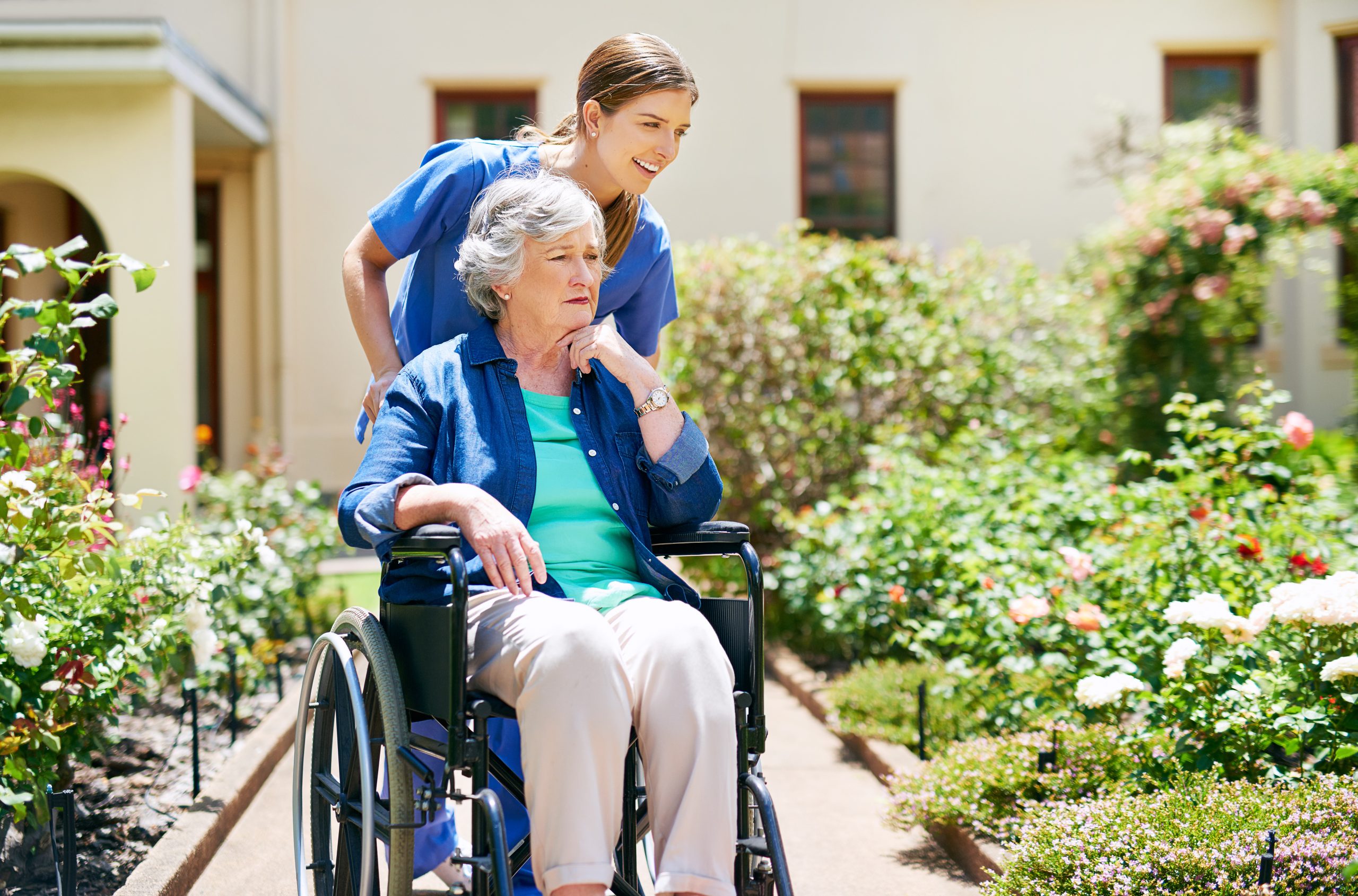 An NDIS participant and support worker outdoors, planning a community outing together